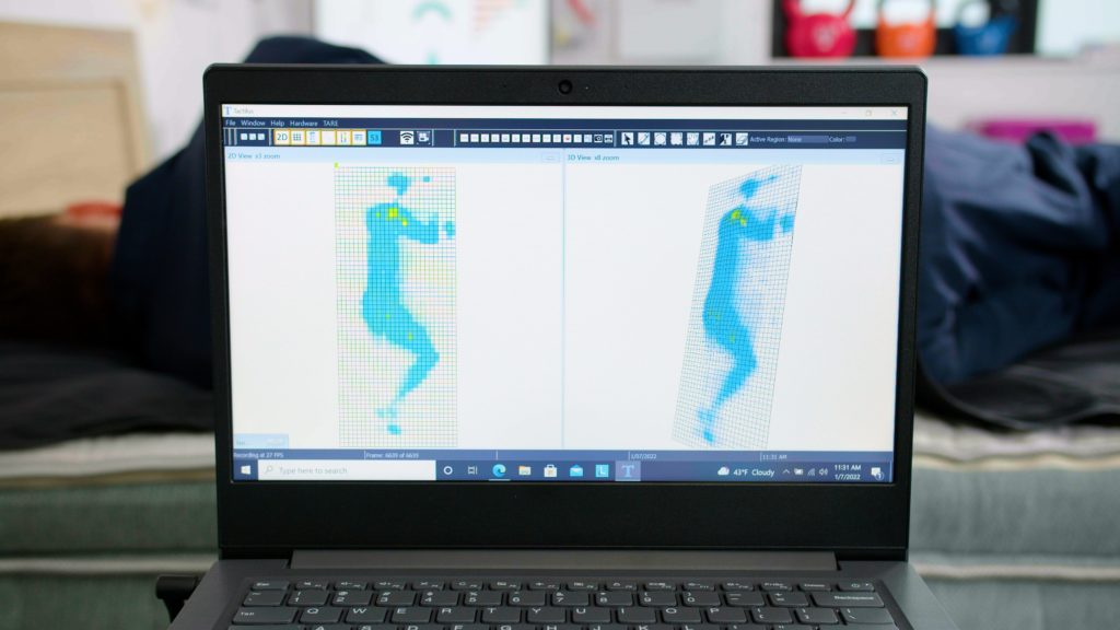 Tester lying on their side on the EcoSleep Luxe Hybrid to test for pressure relief